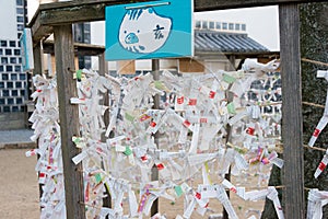 Omikuji tie at  Achi Shrine in Kurashiki, Okayama, Japan. The Omikuji tie is made to drive away bad