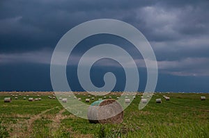 Ominous sky with Bales of Hay