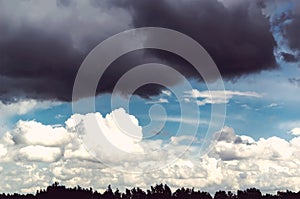 Ominous sky with black cloud and white clouds