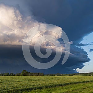 Ominous storm clouds over empty rural landscape in square dimension photo