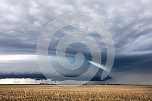 Ominous supercell storm clouds over a field