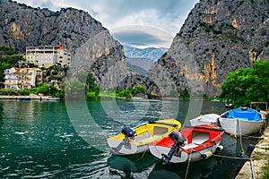 Omis fishing harbor with boats and high mountains, Dalmatia, Croatia