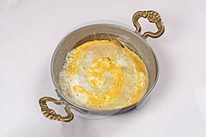 Omlette in copper pan  white background