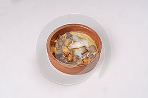 Omlette with patato on a clay plate photo