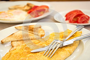 Omlette with toast bread and tomatoes