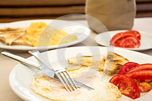 Omlette with toast bread and tomatoes