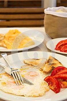 Omlette with toast bread and tomatoes