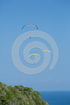 Paragliders flying over Bali, Indonesia photo