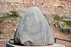 The omphalos stone, navel of the world, Delphi archaeological site along the slope of Mount Parnassus
