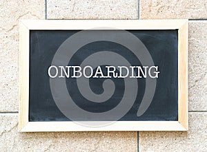 Onboarding, words printed on a blackboard