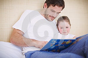 Once upon a time...A devoted father reading his young daughter a bedtime story.