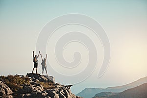 Once youve conquered one mountain you can conquer them all. a man and woman hiking up a mountain.