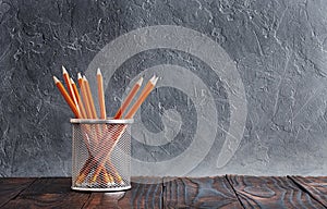 Ð¡oncept of education. Pencils in stand on wall background
