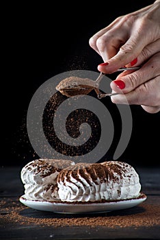 ?oncept of home marshmallows: a woman sprinkling marshmallows with chocolate.