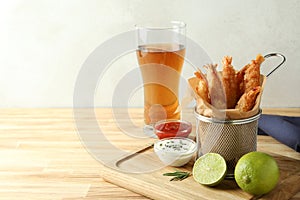 Ð¡oncept of tasty food with deep-fried shrimp on wooden table