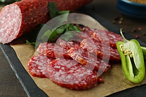 Ð¡oncept of tasty food with salami sausage, close up