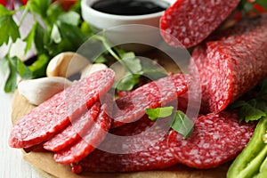 Ð¡oncept of tasty food with salami sausage, close up