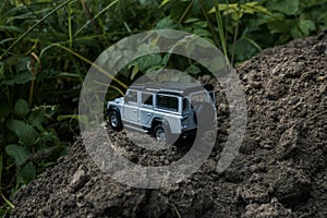 Ð¡oncept travel and racing  for four wheel drive off road vehicle. 4v4 SUV makes its way across rough terrain Toy car