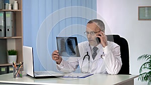 Oncologist calling patient, informing about lung disease, x-ray examination