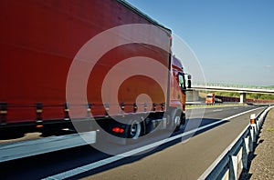 Oncoming red trucks on empty highway in the countryside