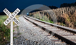 Oncoming train with railroad crossing sign