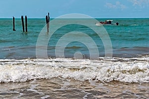 Beach, with rocks, waves and vegetation forming a beautiful maritime landscape. photo