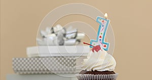 One 1 candle in cupcake pastel background
