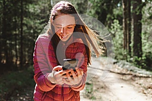 One 13s girl making a video call to her friend in the forest, Online communication concept.Nice sunny spring day