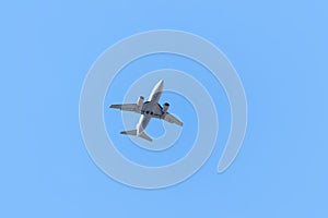One airplane taking off on blue sky background