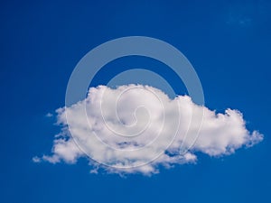 One alone cloud in a dark blue sky