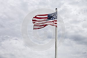 One American Flag blowing in the wind on a windy day