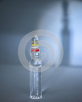 Close-up of a single medical ampoule, bottle or ampoule of medicines on the table.  glass ampoule.