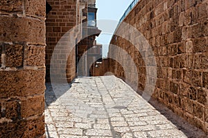 One of the ancient paved narrow historic streets in Old Jaffa on a sunny summer day. Israel