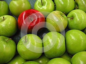 One apple among lots of green