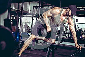 One-arm dumbbell rows in gym