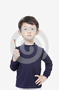 One asian boy child holds painting brush