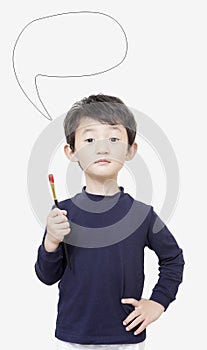 One asian boy child holds painting brush