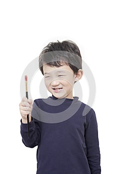 One asian boy child holds painting brush