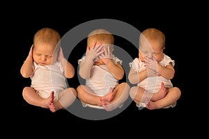 One baby three times in hear see speak no evil poses