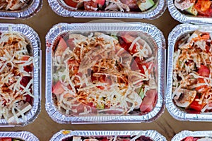 One of a batch of containers with vegetables and mushrooms prepared for baking