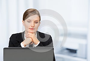 One beautiful business woman with laptop in the office