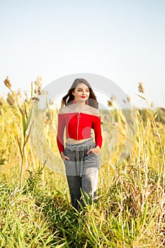 One beautiful female caucasian high school senior girl in red crop top sweater