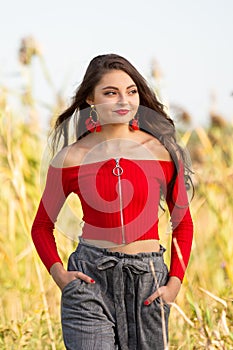 One beautiful female caucasian high school senior girl in red crop top sweater