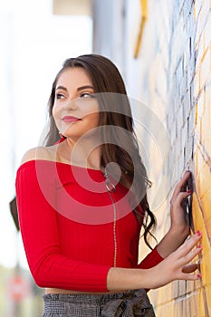 One beautiful female caucasian high school senior girl in red crop top sweater photo