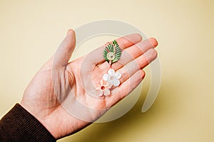 One beautiful flower martisor on the palm of a woman.