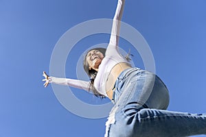 One beautiful young woman jumping and dancing in the city. Concept of friendship, joy
