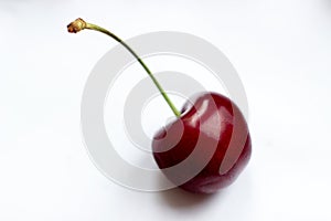 One berry, one cherry on white background