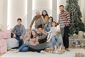 One big stylish family at Christmas eve. Portrait of noel large family gathering. Young grandparents and grandmother