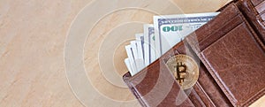 One bitcoin with dollar bills in wallet, virtual cryptocurrency trading concept