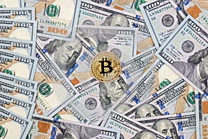 One bitcoin with hundred dollars bills